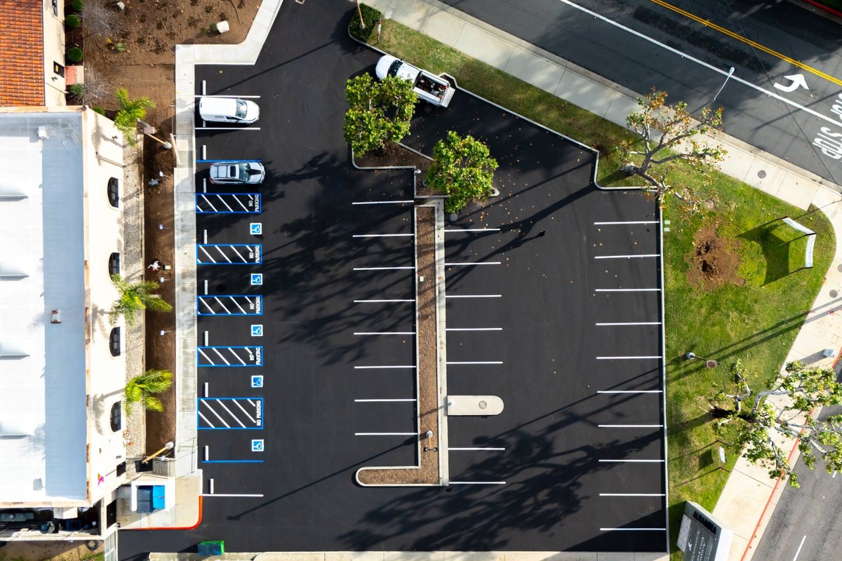 Aerial view of a freshly surfaced commercial parking lot with new striping